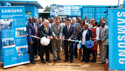 Front left to right: Hans Ludolph, founder and leading member of Fodisong; Albert Chanee, head of the Gauteng Department of Economic Development; and Minkyu Lee, vice president and CFO at Samsung Electronics Africa, officially open the Digital Village as government officials and community members look on.